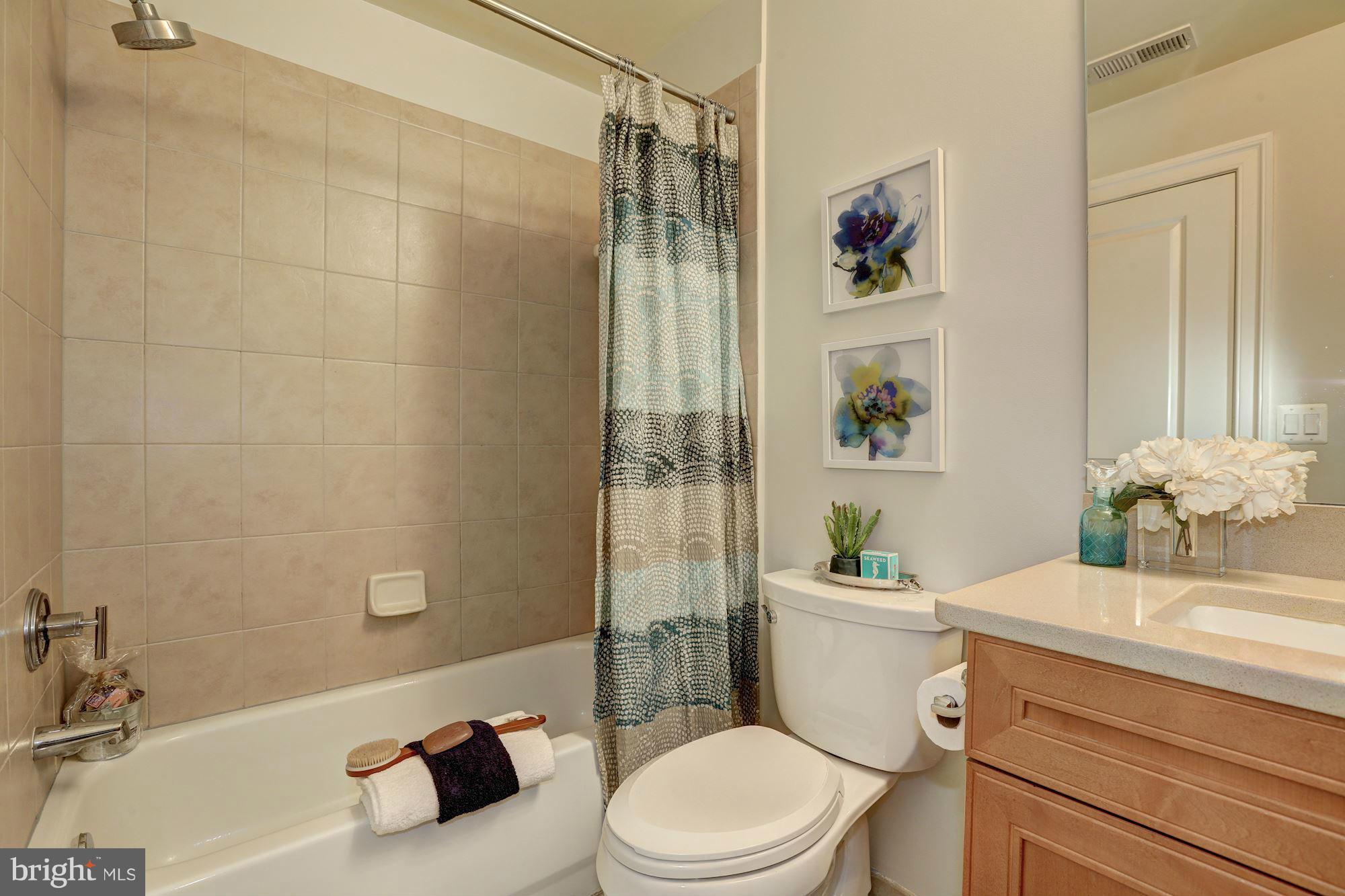 1407 W Street Northwest, Unit 202 Washington, DC 20009 - Photo 29 of 30 a bathroom with a sink a toilet and shower