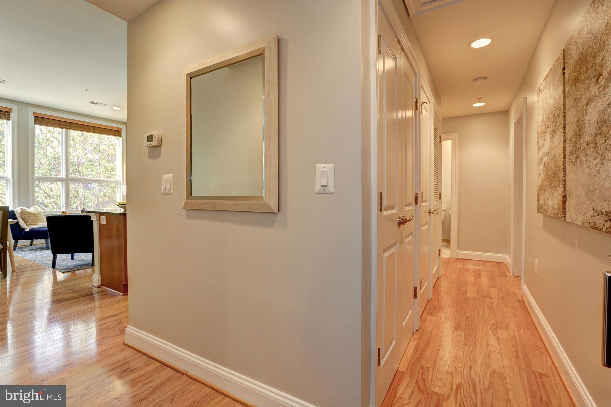 1407 W Street Northwest, Unit 202 Washington, DC 20009 - Photo 6 of 30 a view of a hallway with wooden floor and a bathroom