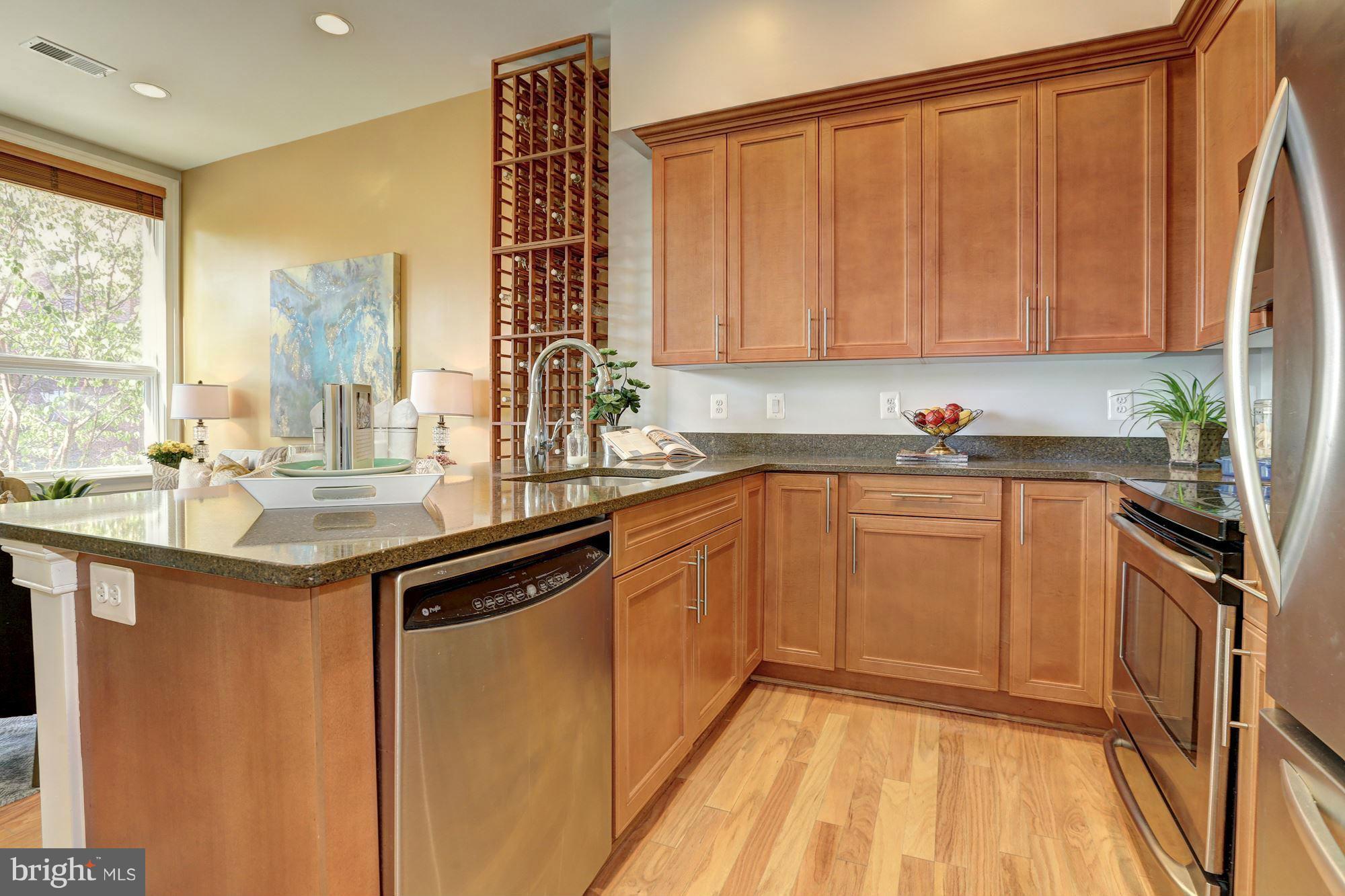 1407 W Street Northwest, Unit 202 Washington, DC 20009 - Photo 9 of 30 a kitchen with a sink and cabinets