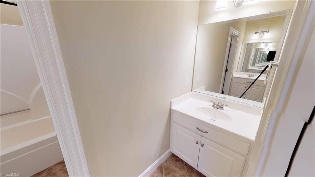256 Stonecroft Road Mount Airy, NC 27030 - Photo 13 of 30 Main level full bath has two single-bowl vanities and tub/shower.