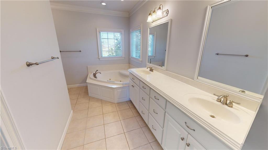 256 Stonecroft Road Mount Airy, NC 27030 - Photo 18 of 30 Master bath with double vanity and jetted tub with waterfall feature.