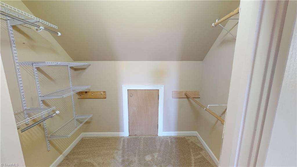 256 Stonecroft Road Mount Airy, NC 27030 - Photo 23 of 30 Upstairs walk-in closet with small door to lighted attic storage.