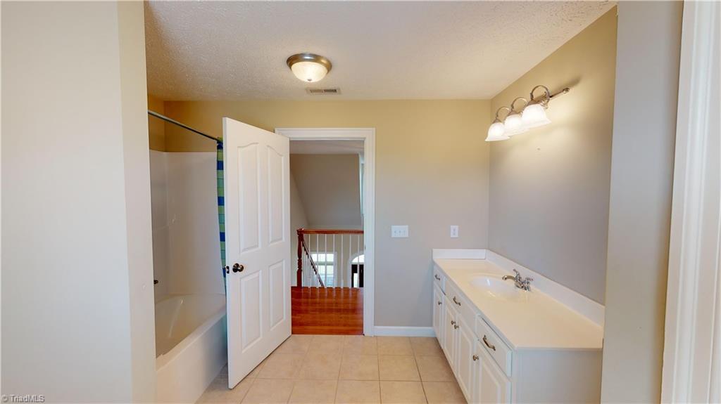 256 Stonecroft Road Mount Airy, NC 27030 - Photo 24 of 30 Spacious upstairs bathroom has tub/shower, large vanity and linen closet.