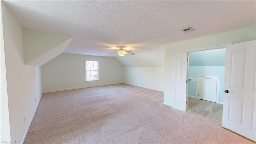 256 Stonecroft Road Mount Airy, NC 27030 - Photo 25 of 30 Upstairs bedroom with walk-in closet and lighted attic storage.