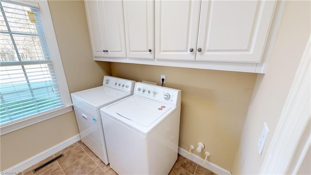 256 Stonecroft Road Mount Airy, NC 27030 - Photo 26 of 30 Laundry room on main level with plumbing for sink, cabinets and hanging clothes rod.