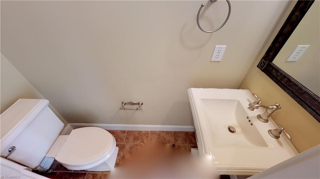 256 Stonecroft Road Mount Airy, NC 27030 - Photo 27 of 30 Half Bath on main level features tile floors, pedestal sink and a pocket door!