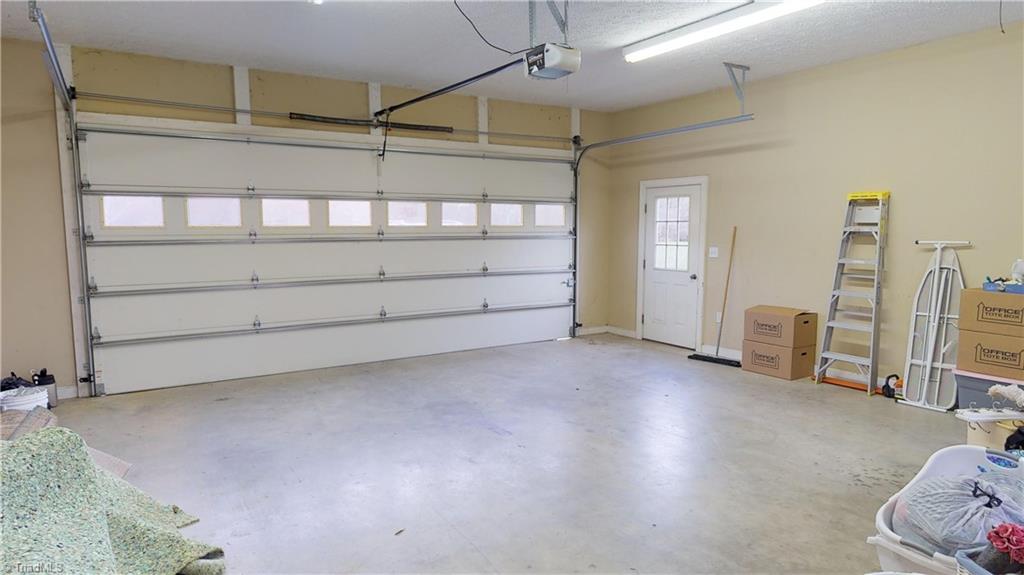 256 Stonecroft Road Mount Airy, NC 27030 - Photo 28 of 30 2 car garage with pull down attic steps that leads to floored storage.