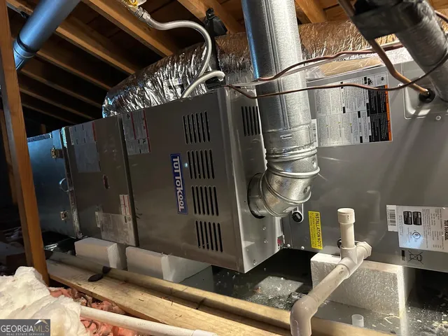 a view of a house with a yard chairs and iron fence
