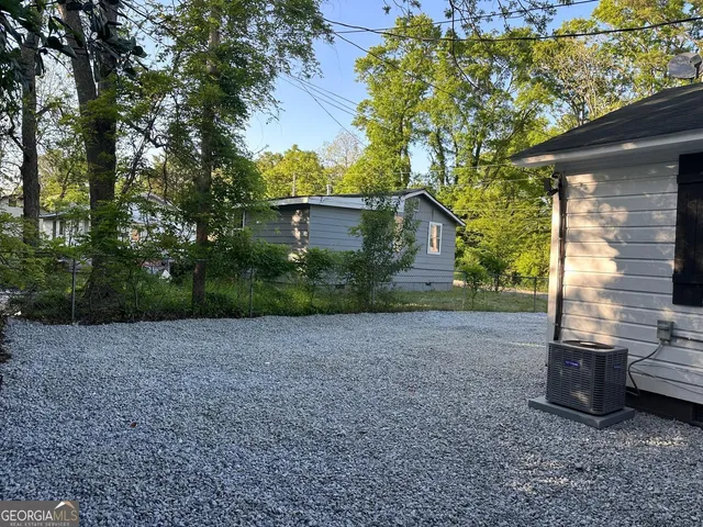 a view of a backyard with large tree