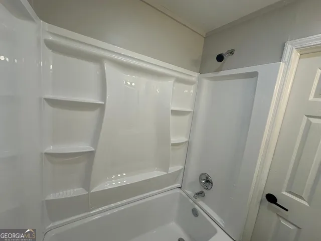 a kitchen with kitchen island a counter space a sink appliances and cabinets