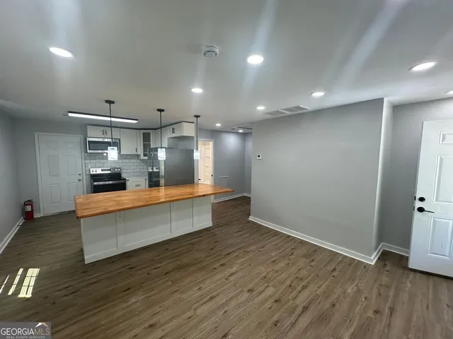 a kitchen with a refrigerator stove and microwave
