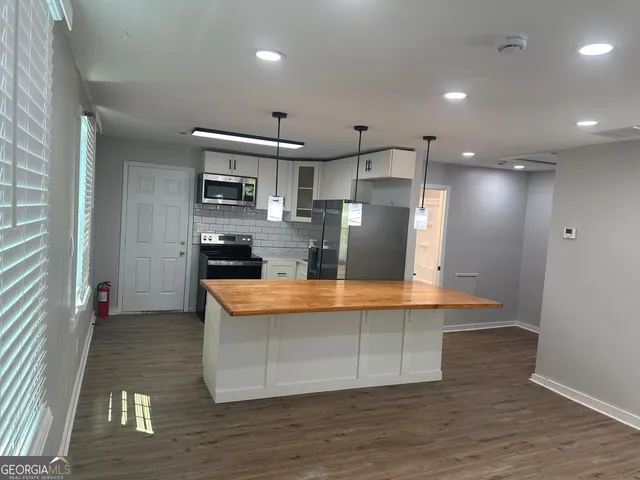 a kitchen with a refrigerator stove and microwave