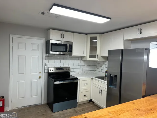 a view of entryway and hall with wooden floor