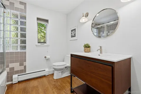 a bathroom with a sink mirror and toilet