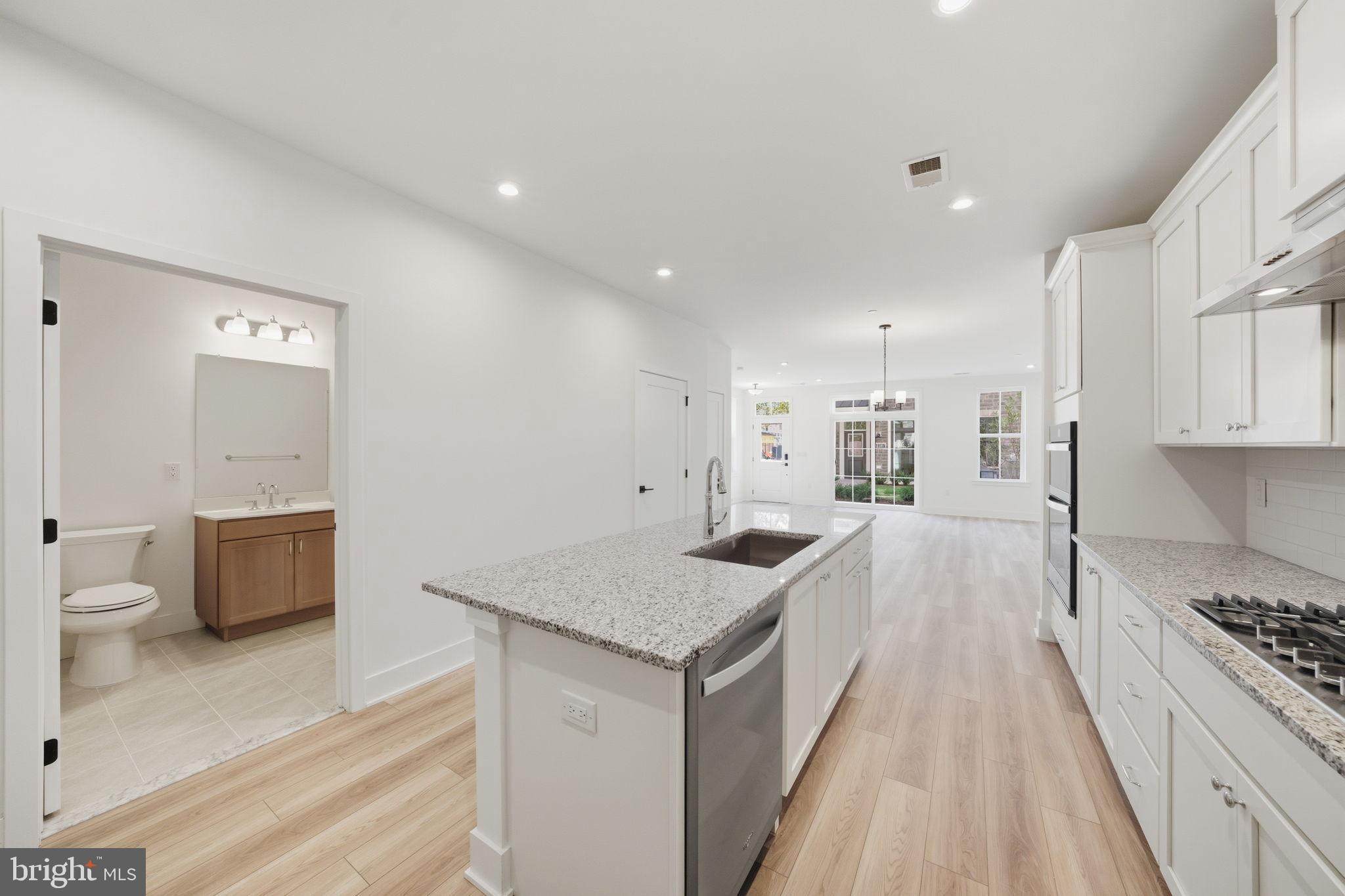 8101 Donatello Drive Princeton, NJ 08540 - Photo 12 of 26 a view of a kitchen with kitchen island a sink stove and wooden floor