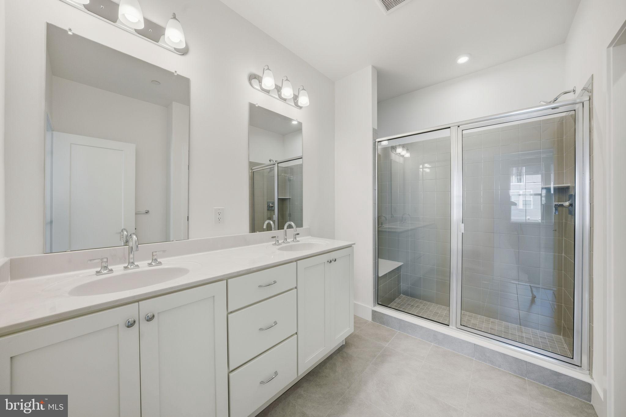 8101 Donatello Drive Princeton, NJ 08540 - Photo 21 of 26 a bathroom with a double vanity sink mirror and shower