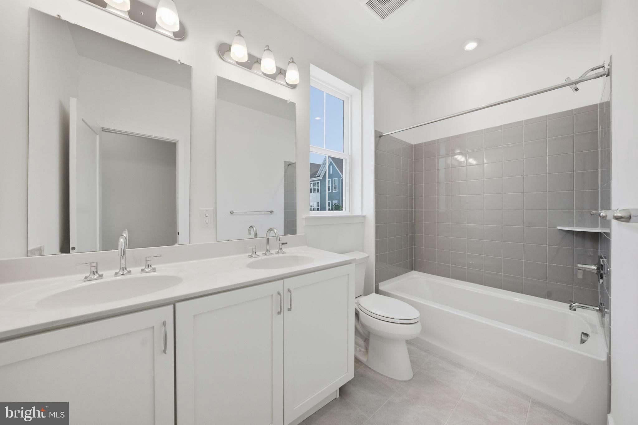 8101 Donatello Drive Princeton, NJ 08540 - Photo 24 of 26 a bathroom with a double vanity sink toilet mirror and bathtub