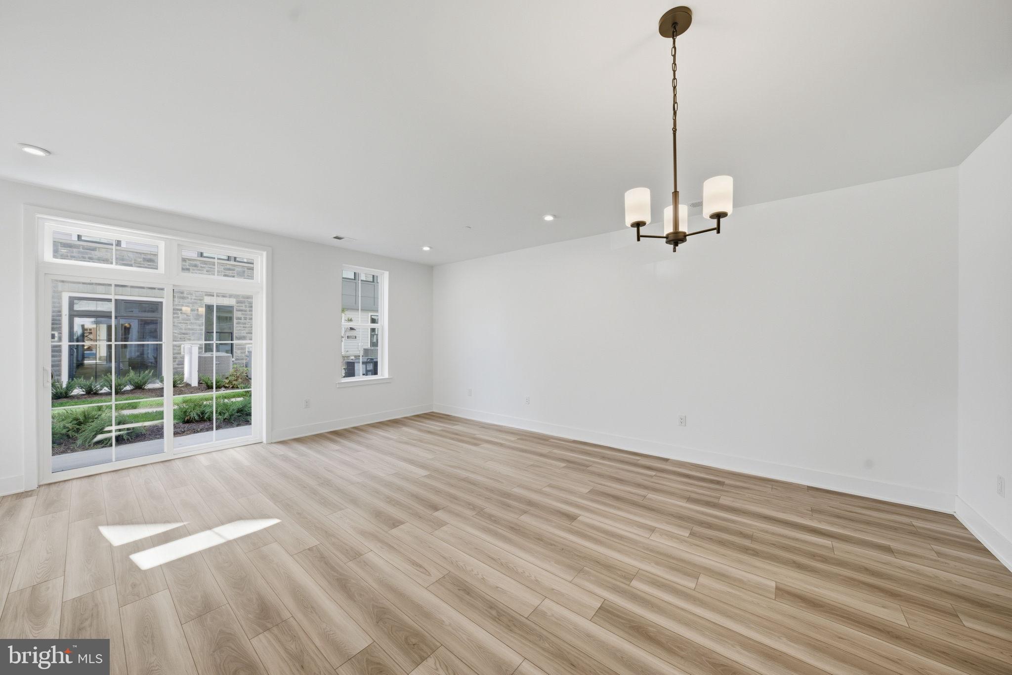 8101 Donatello Drive Princeton, NJ 08540 - Photo 8 of 26 a view of empty room with wooden floor and fan