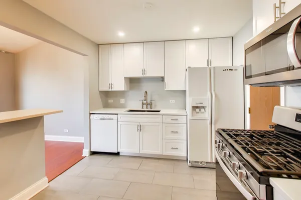a kitchen with cabinets and a stove top oven
