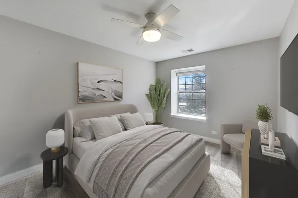 a bedroom with a bed and a painting on the wall