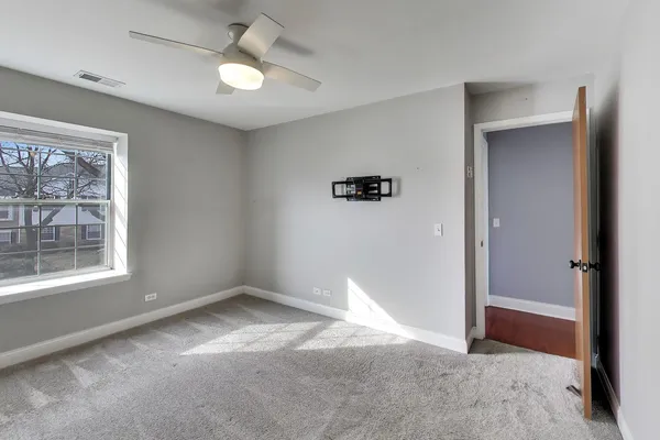 an empty room with windows and entrance