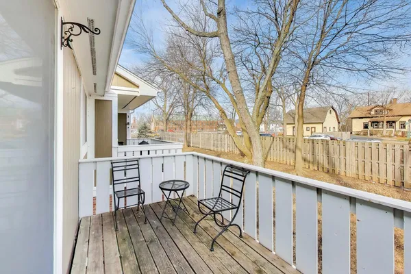 a view of balcony with wooden floor and outdoor seating
