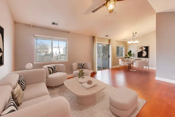 a living room with furniture and a wooden floor