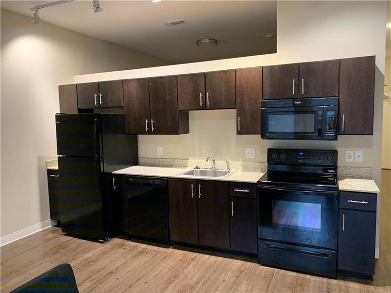 1655 Fifth Avenue, Unit 309 Pittsburgh, PA 15219 - Photo 15 of 16 a kitchen with a stove and a refrigerator