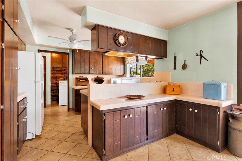 5500 Oil Well Road Phelan, CA 92371 - Photo 9 of 65 a kitchen with a sink a stove and cabinets