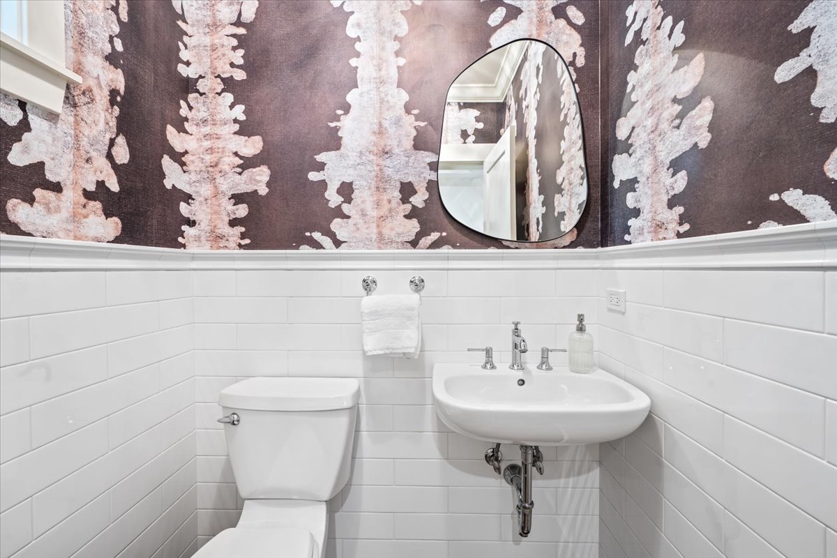 1303 Maple Avenue Wilmette, IL 60091 - Photo 18 of 33 a bathroom with a toilet sink and mirror