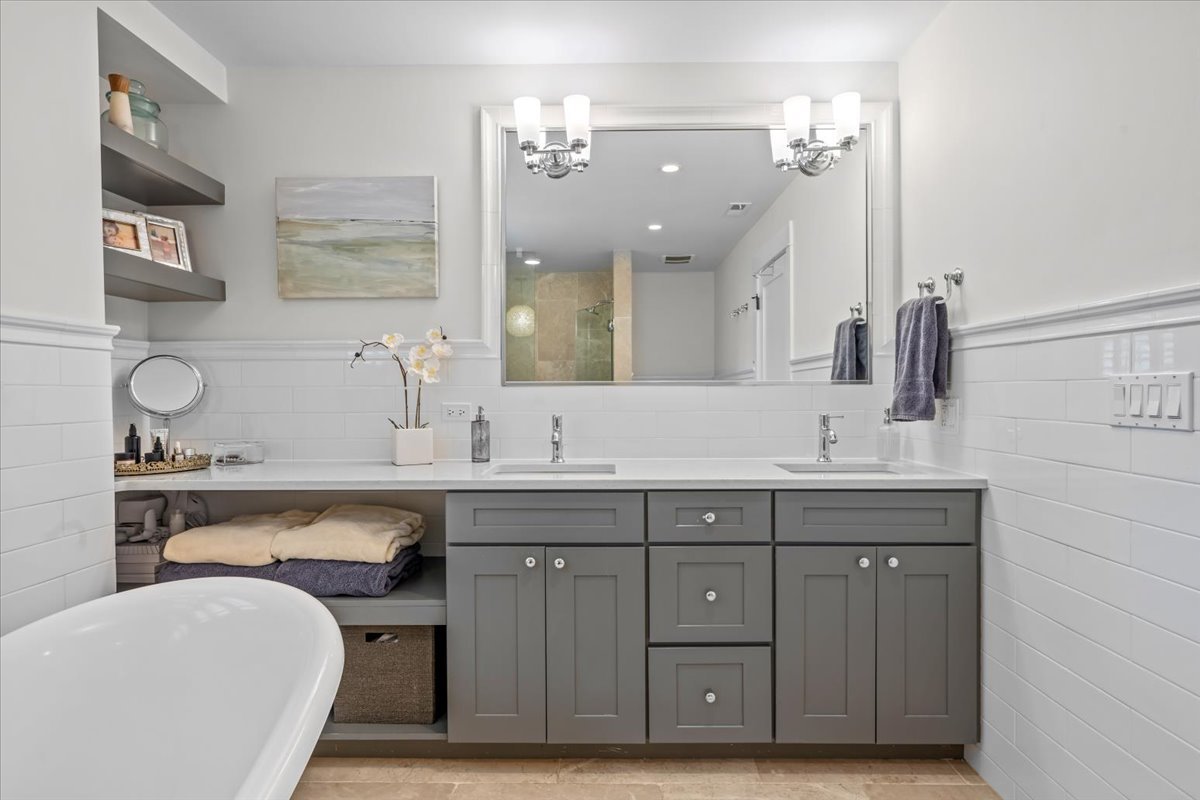 1303 Maple Avenue Wilmette, IL 60091 - Photo 22 of 33 a spacious bathroom with a sink double vanity and a mirror
