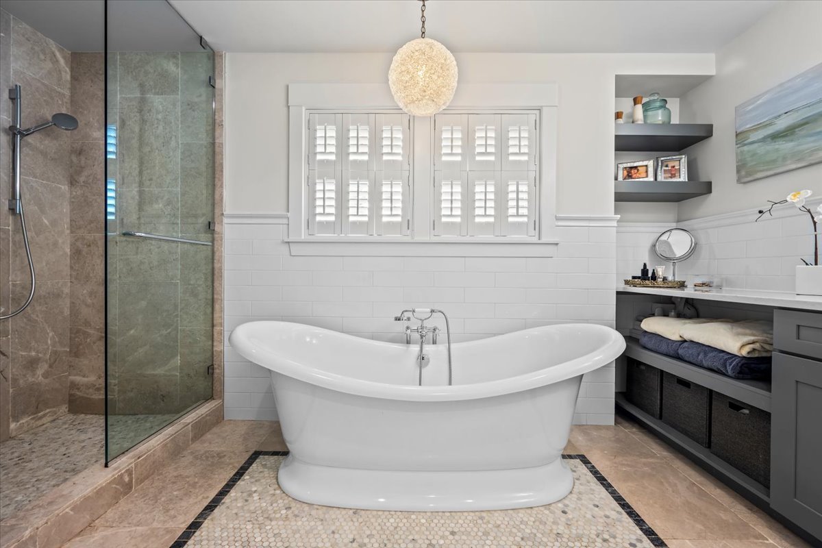 1303 Maple Avenue Wilmette, IL 60091 - Photo 23 of 33 a white bath tub sitting in a bathroom next to a window