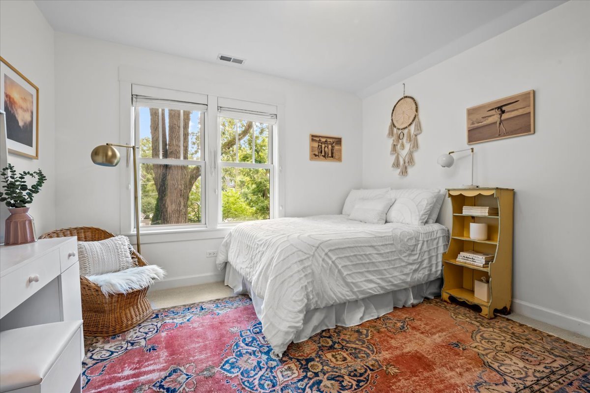 1303 Maple Avenue Wilmette, IL 60091 - Photo 24 of 33 a bedroom with a bed and wooden floor