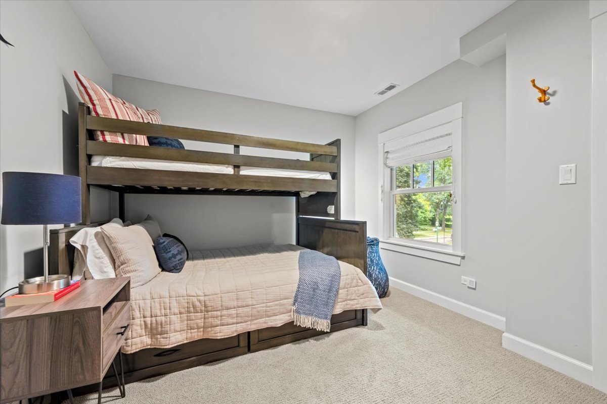1303 Maple Avenue Wilmette, IL 60091 - Photo 25 of 33 a bedroom with a bed and window