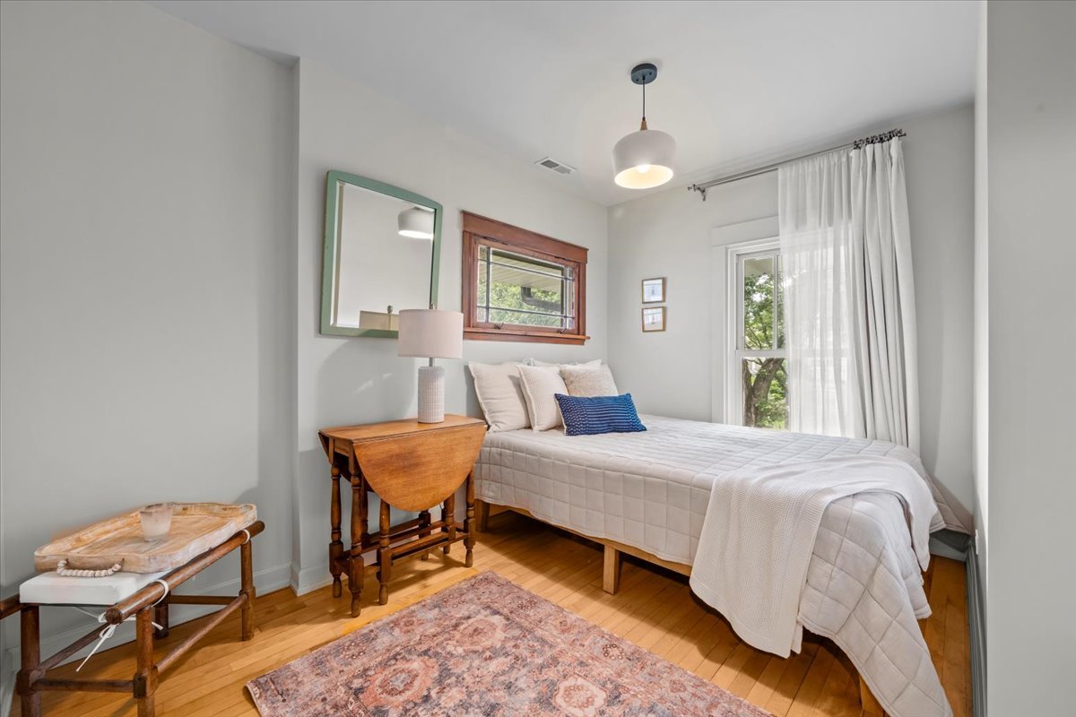 1303 Maple Avenue Wilmette, IL 60091 - Photo 27 of 33 a bedroom with a bed and wooden floor