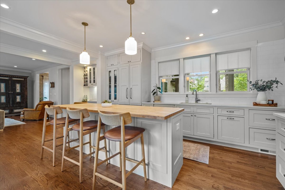 1303 Maple Avenue Wilmette, IL 60091 - Photo 7 of 33 a kitchen with a table chairs sink and cabinets