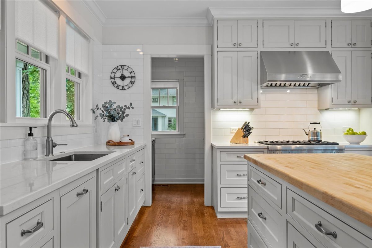 1303 Maple Avenue Wilmette, IL 60091 - Photo 8 of 33 a kitchen with stainless steel appliances granite countertop a sink and cabinets