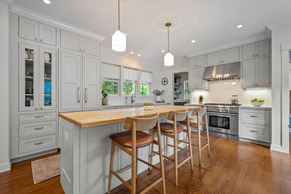 1303 Maple Avenue Wilmette, IL 60091 - Photo 9 of 33 a kitchen with stainless steel appliances granite countertop a stove a sink and a refrigerator