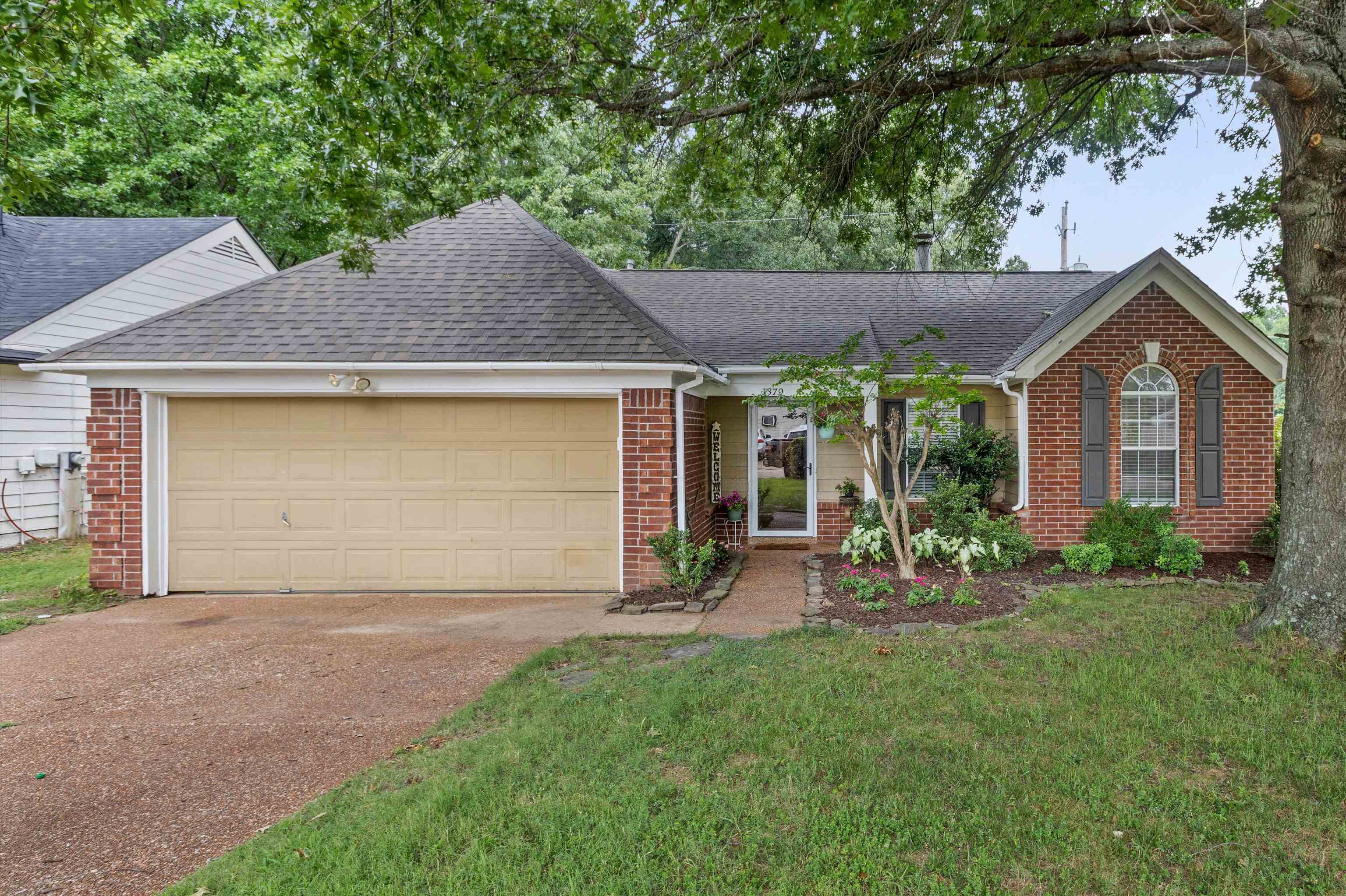 Traditional brick and siding exterior with an attached garage