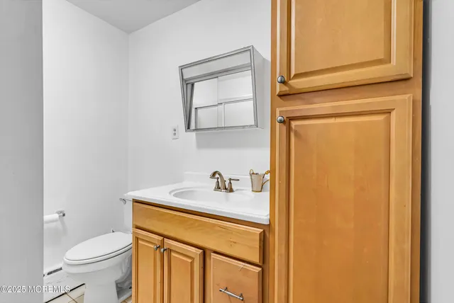a white toilet sitting next to a white sink
