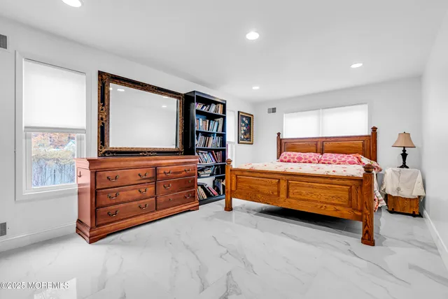 a bedroom with a bed and a book shelf