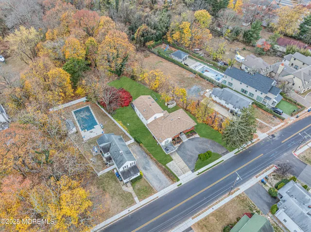an aerial view of a house with garden space ocean view