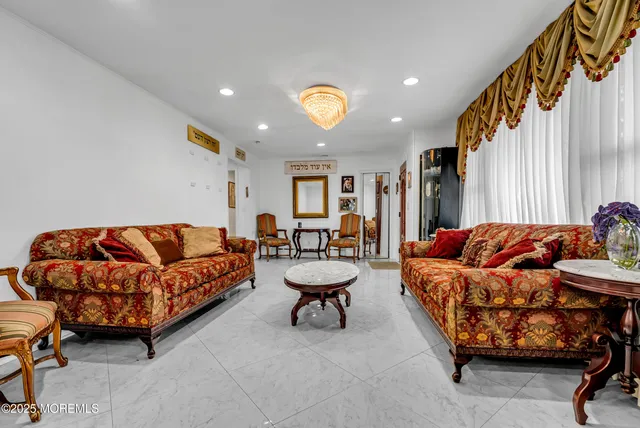 a living room with a couch and a chandelier