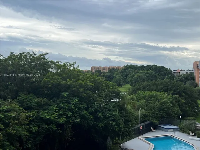 a view of a city with lush green forest
