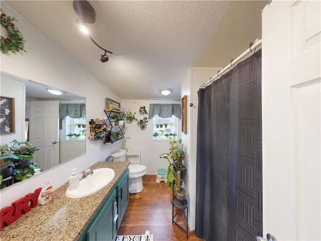 a bedroom with a bed and large windows