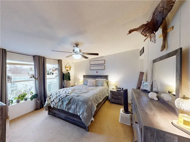 a bedroom with a bed couch and a window