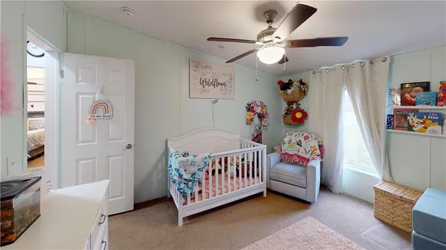 a bedroom with furniture and a baby crib