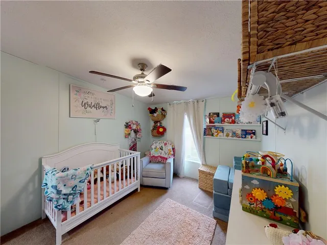 a living room with lots of furniture and baby bed