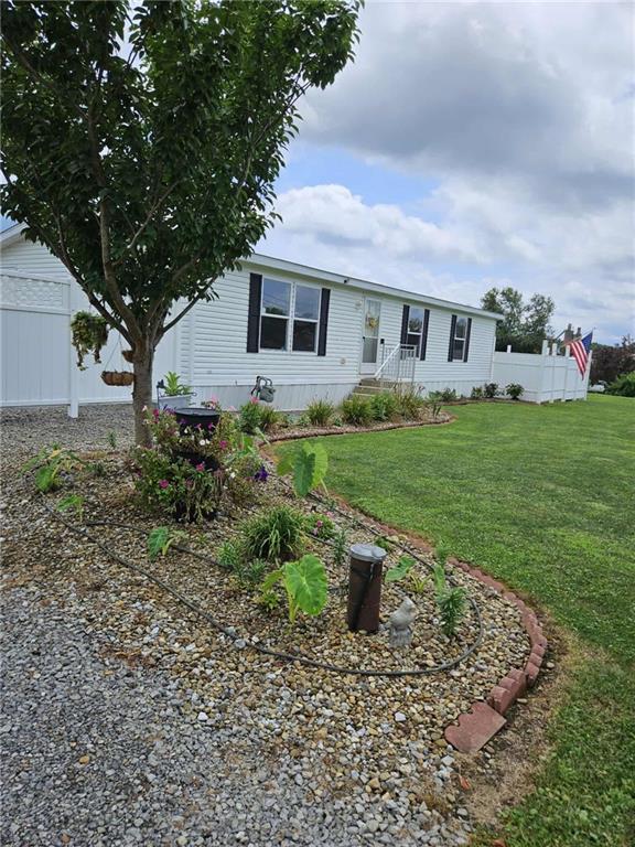 145 Boomerang Road Harrisville, PA 16038 - Photo 2 of 37 a front view of a house with garden