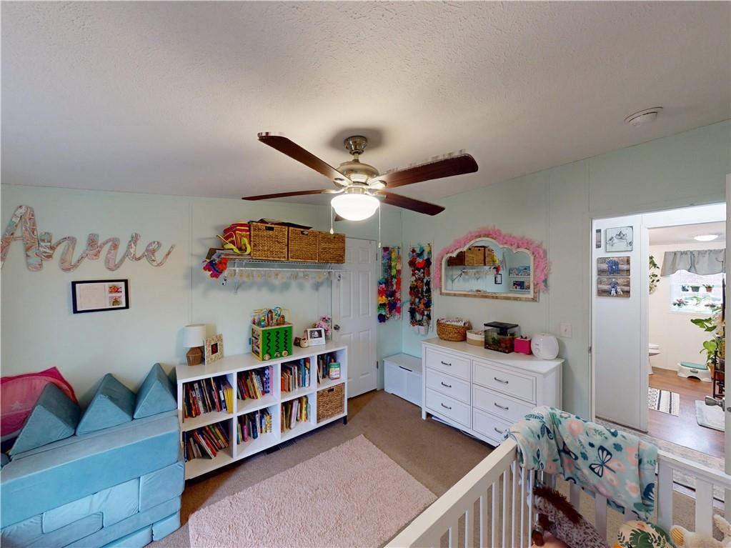 145 Boomerang Road Harrisville, PA 16038 - Photo 21 of 37 a living room with lots of furniture and baby bed